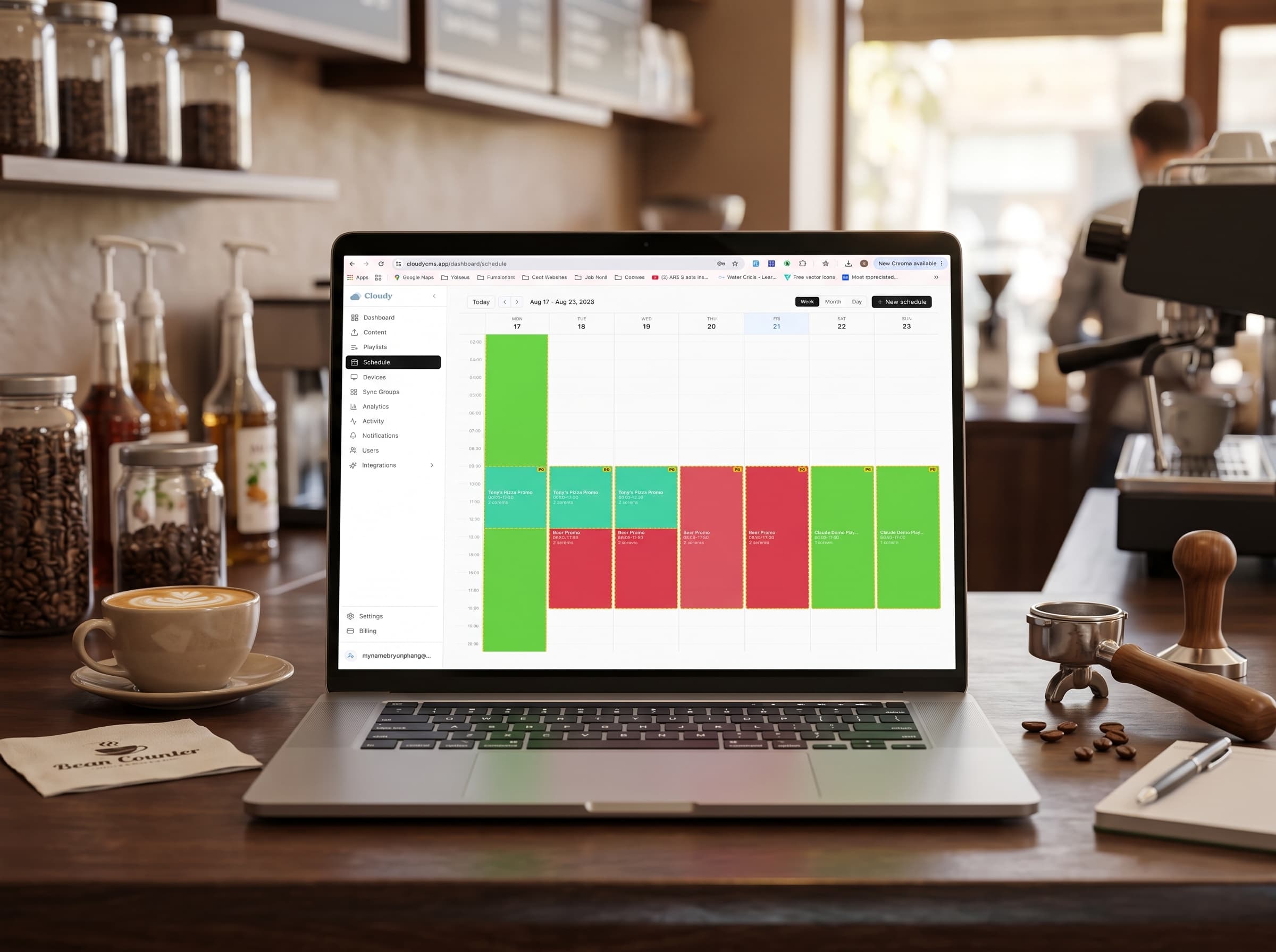 The Cloudy schedule calendar open on a laptop at a café back-counter.